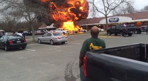 Man watching a car on fire