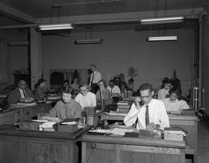 old photo of people working in an office