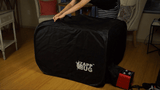 a animated gif of a lady loading the ZappBug Oven 2 with a nightstand and carry on luggage